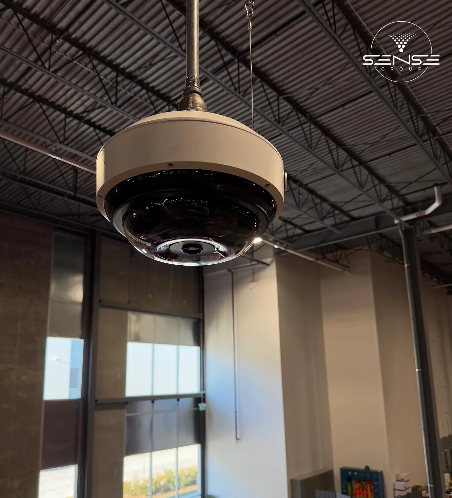 UNV multi-lens panoramic camera hanging from a warehouse ceiling