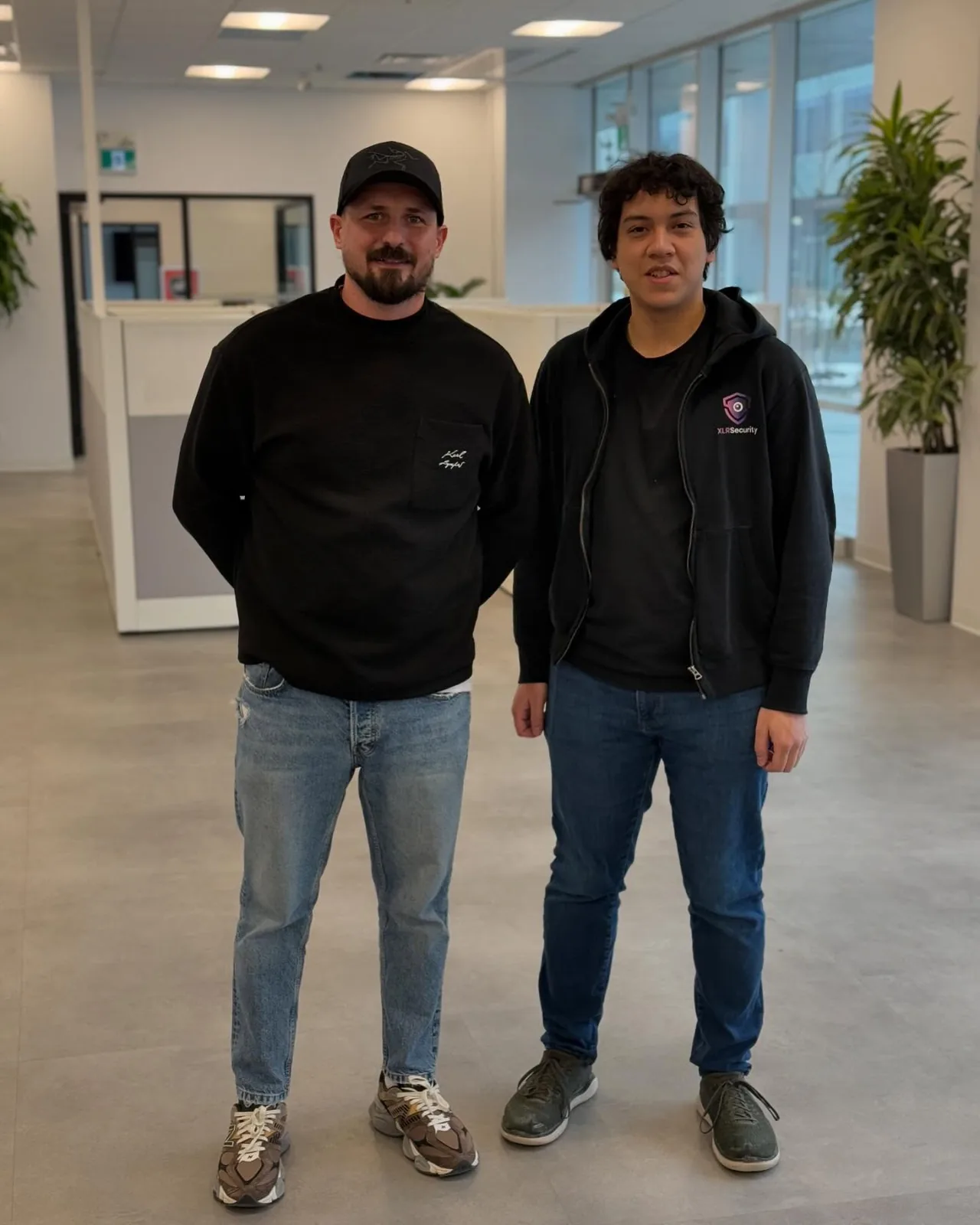 Vitaly Sukhina with a partner from XLR Security in an office lobby