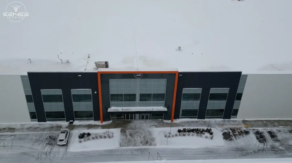 Aerial front view of commercial warehouse entrance in Milton Ontario during professional CCTV security camera installation by Sense Group