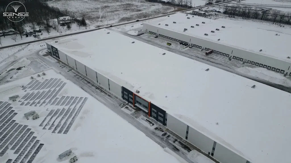 Drone view of large commercial warehouse facility in Ontario during security camera installation project with full perimeter coverage